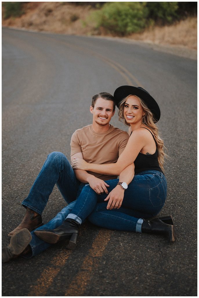couple sits in road together by Amarillo Portrait Photographer