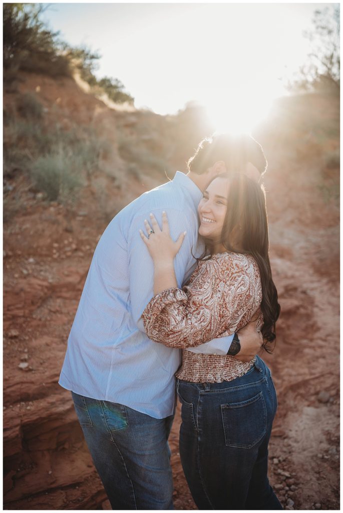 Woman being hugged by her man at golden hour engagement session
