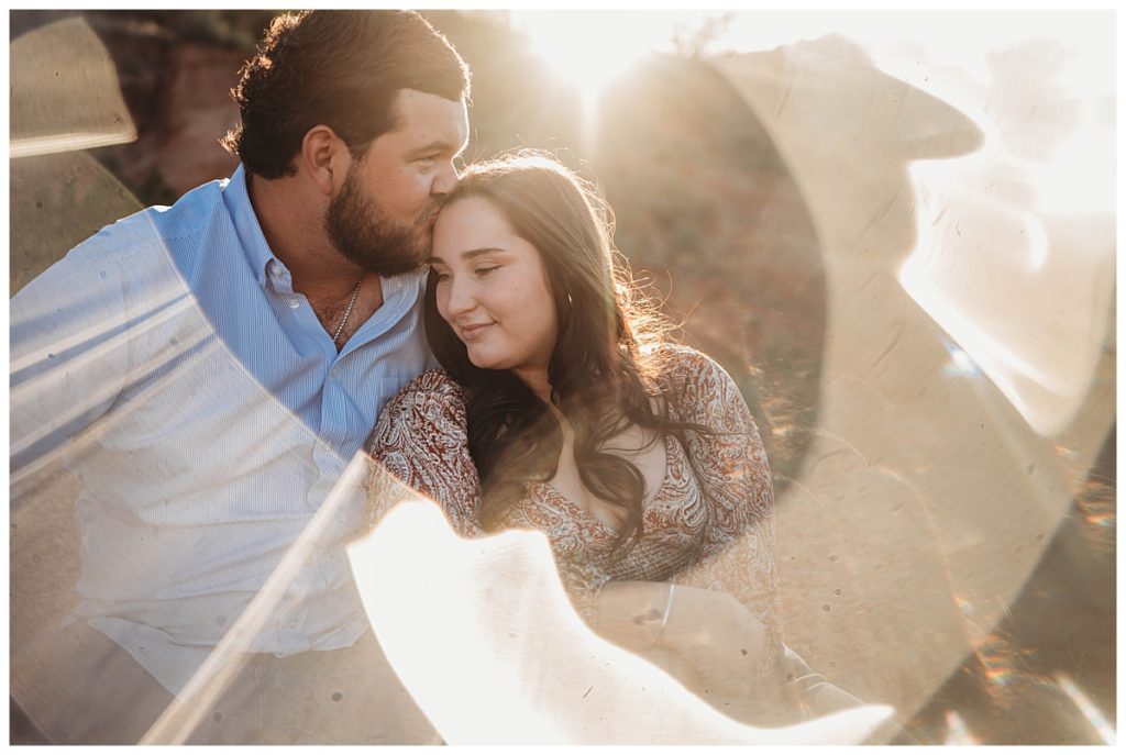 fiance kissing his bride in sunlight by Amarillo photographer