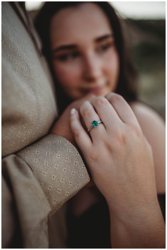 emerald engagement ring on new fiance by Three Feather Photo Co