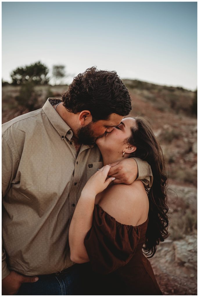 man and woman kissing outside by Three Feather Photo Co