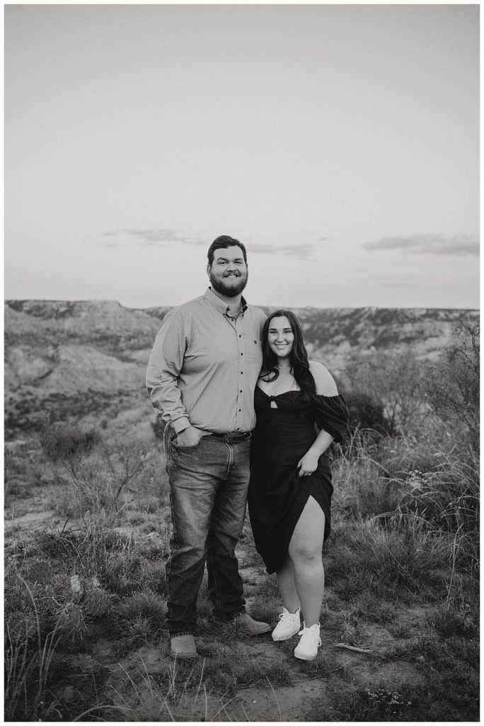 engaged couple smiling in nature by Three Feather Photo Co