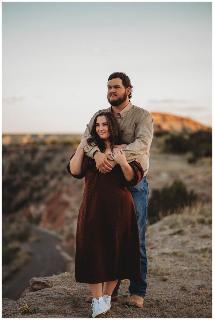man embracing woman in west Texas nature by Amarillo photographer