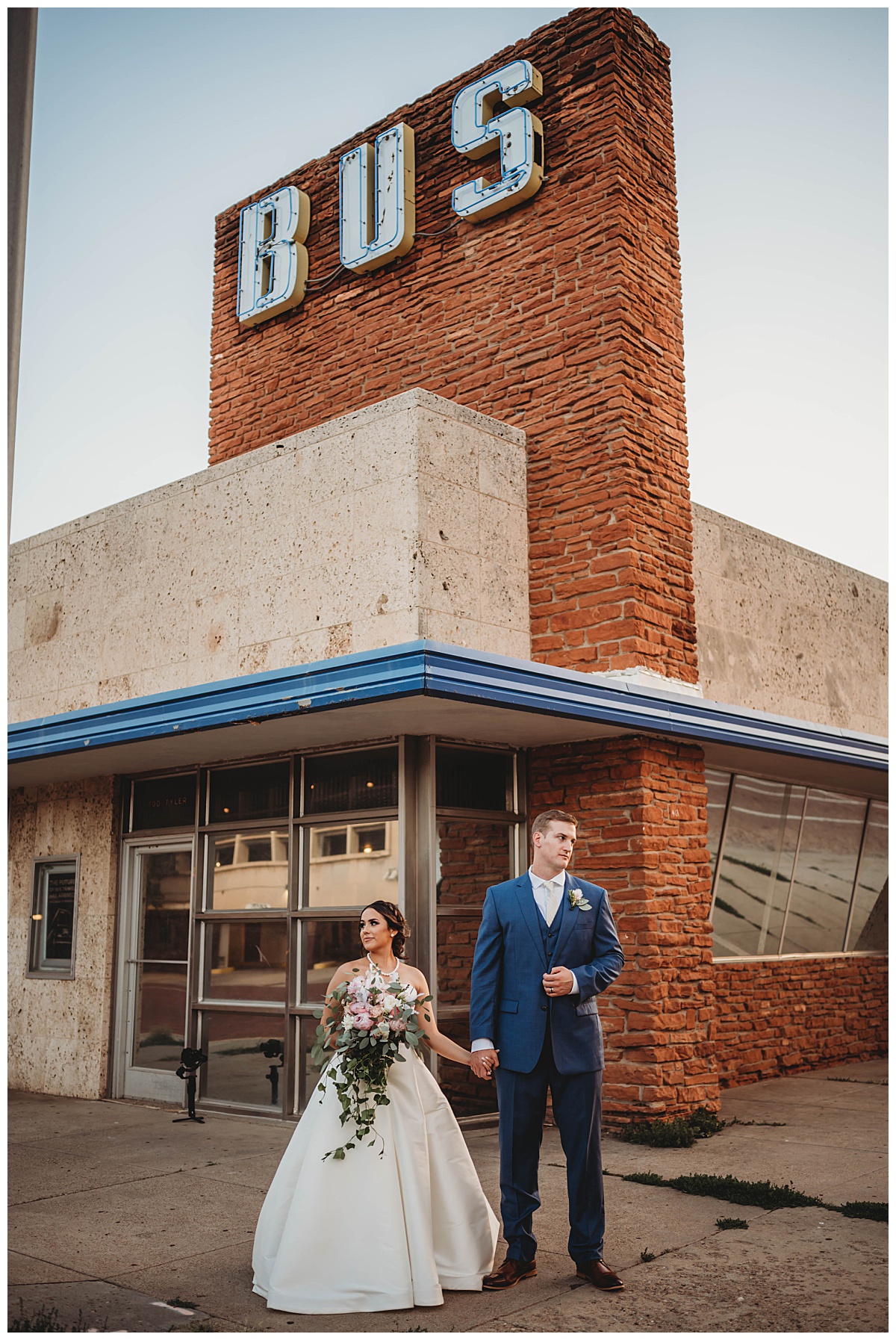 Couple holds hands in front of building for Amarillo Photographer