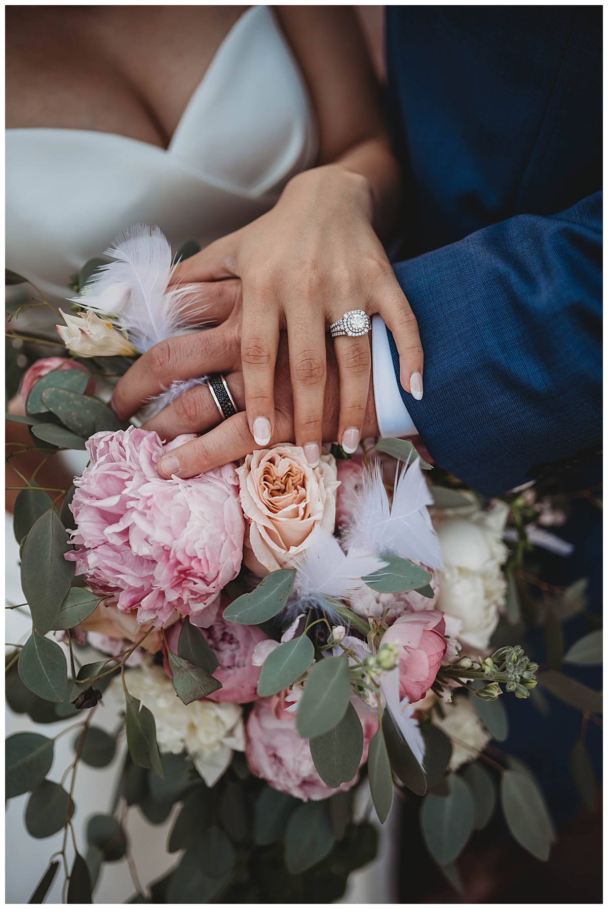 Hands with rings rest on bridal florals at upscale Texas wedding