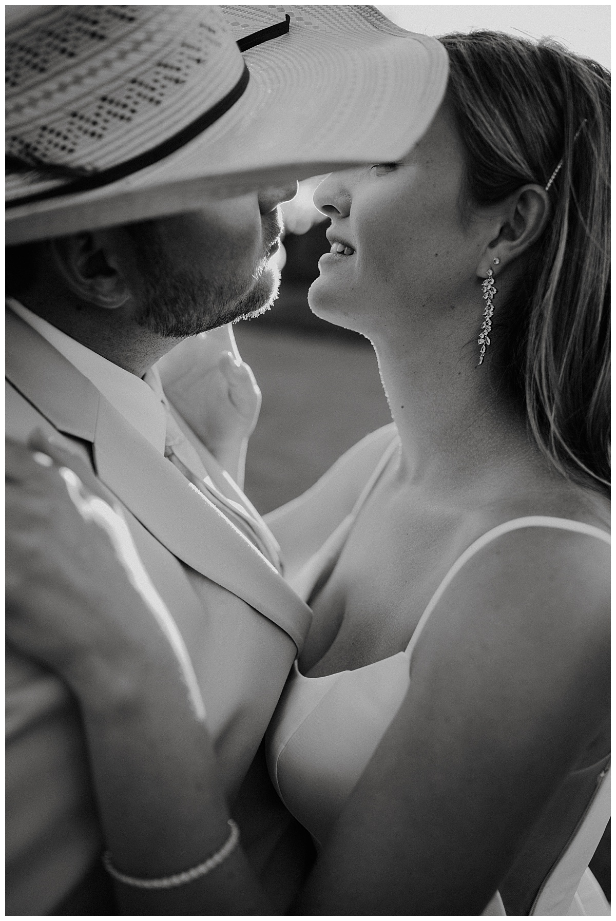 Newlyweds lean to kiss by Amarillo portrait photographer