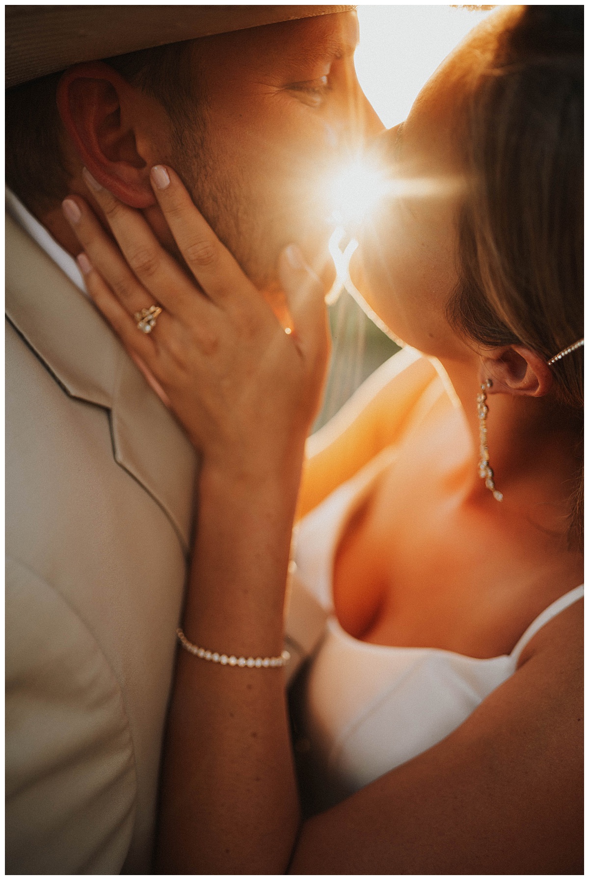 Light shines at couple kisses at intimate backyard wedding 